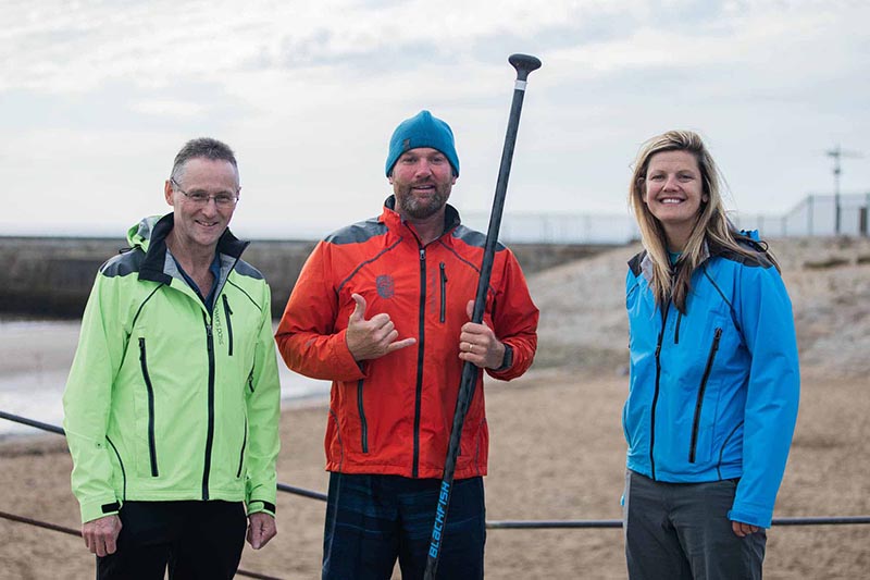 Brendon Prince centre at Seaham Harbour with Fraser Ranson and Emma Nichol of local company Showers Pass UK