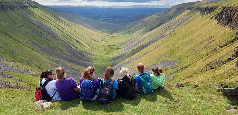 Walk and Talk Trust supporters take in the views of High Cup Nick in the North Pennines